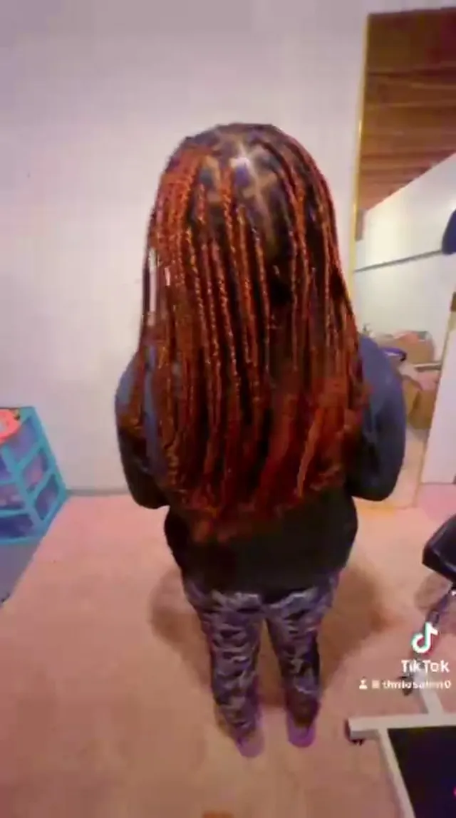 Back view of long copper-red knotless box braids done by Dudu Salon