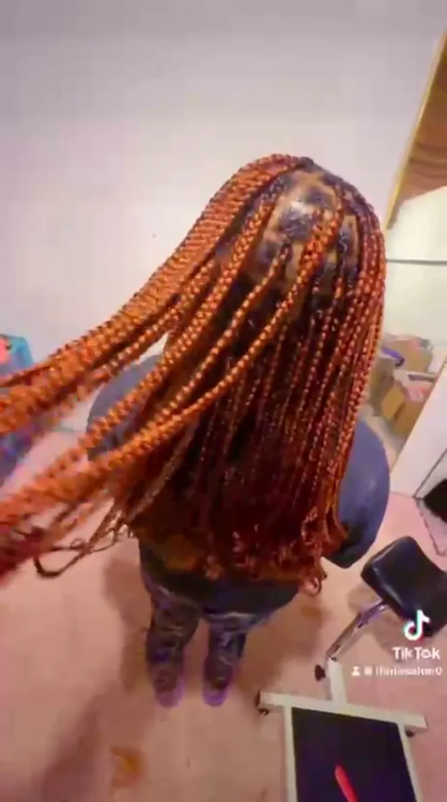 Top view of copper-red box braids showing the neat square parts